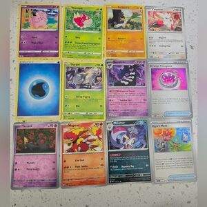 Pokemon assorted card lot with purple, yellow, green, blue, orange, pink,12 card